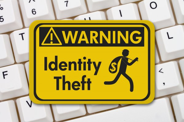 id watchdog identity theft protection yellow sign identity theft warning on white computer keyboard